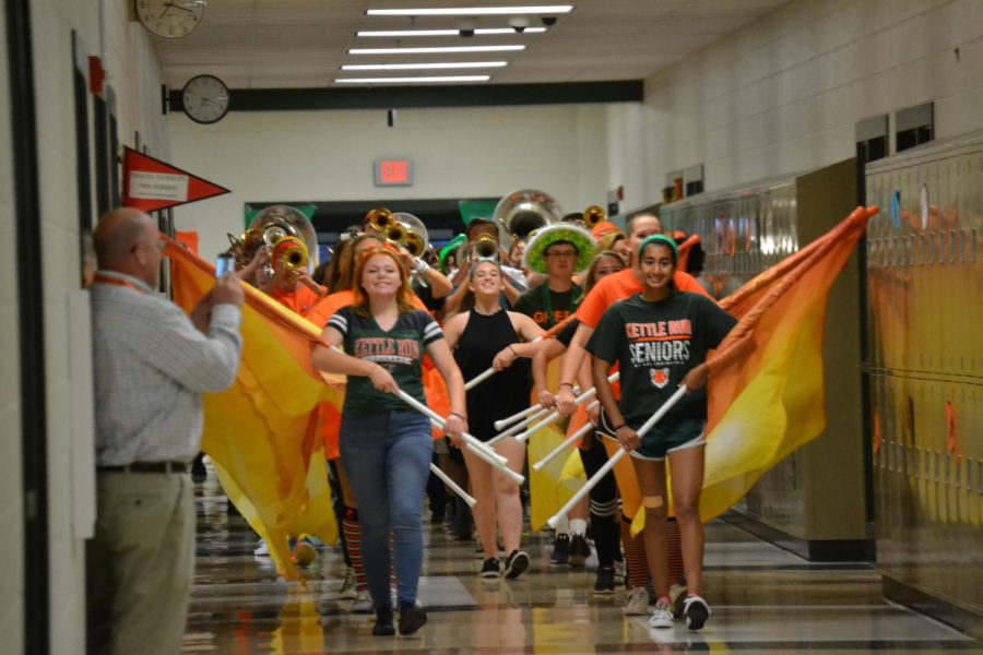 Playing the Kettle Run “Fight Song,” the marching band storms the halls on a Friday
morning, a weekly occurrence to support the Varsity football team